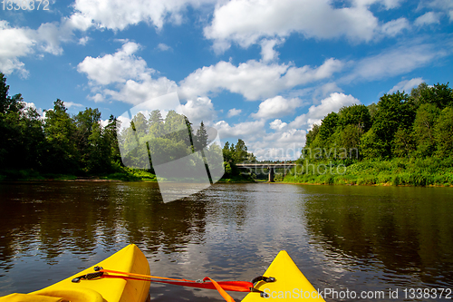 Image of Yellow boat ride by the river.