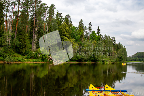 Image of Yellow boat ride by the river.