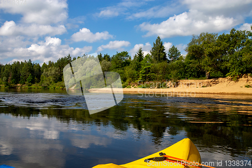 Image of Yellow boat ride by the river.