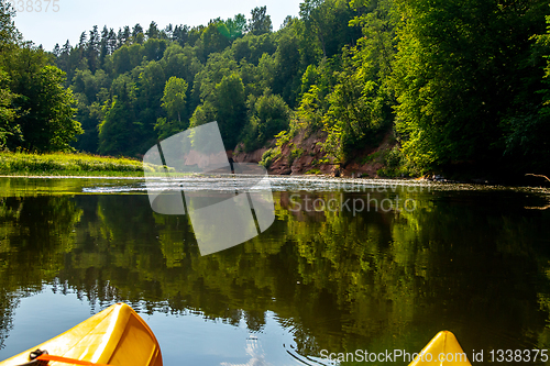 Image of Yellow boat ride by the river.