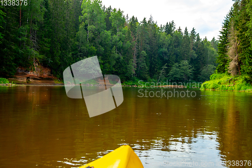 Image of Yellow boat ride by the river.