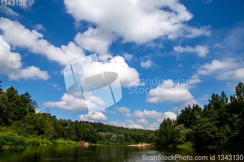 Image of Landscape with river, forest and blue sky.