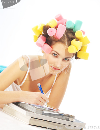 Image of A writing woman in hair curles