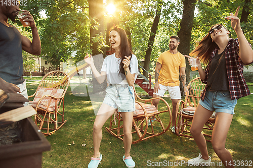 Image of Happy friends are having beer and barbecue party at sunny day