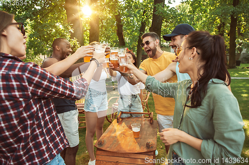 Image of Happy friends are having beer and barbecue party at sunny day