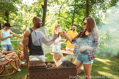 Image of Happy friends are having beer and barbecue party at sunny day