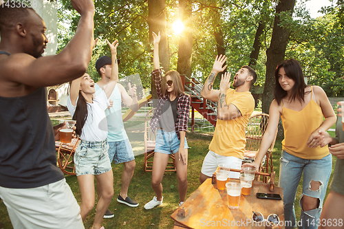 Image of Happy friends are having beer and barbecue party at sunny day