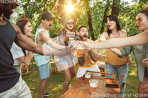 Image of Happy friends are having beer and barbecue party at sunny day