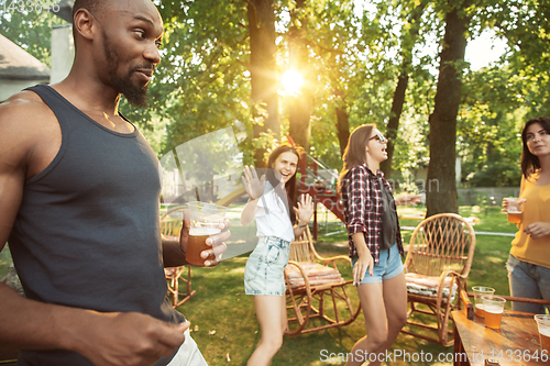 Image of Happy friends are having beer and barbecue party at sunny day