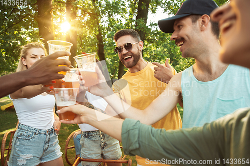 Image of Happy friends are having beer and barbecue party at sunny day