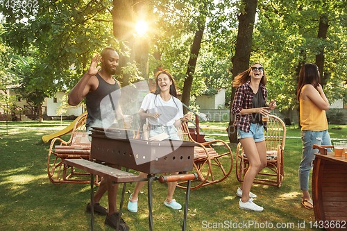 Image of Happy friends are having beer and barbecue party at sunny day