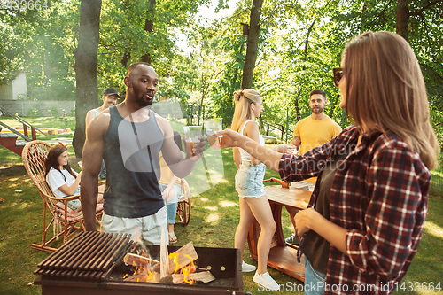 Image of Happy friends are having beer and barbecue party at sunny day