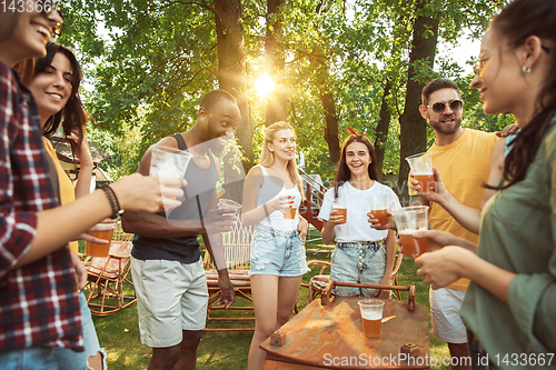 Image of Happy friends are having beer and barbecue party at sunny day