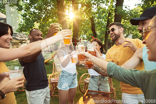 Image of Happy friends are having beer and barbecue party at sunny day