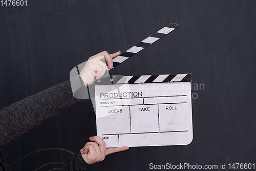 Image of movie clapper on balck chalkboard background