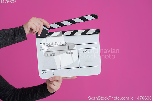 Image of movie clapper on pink background