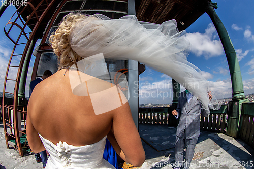 Image of Bride with groom in church on blue sky background.