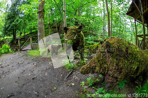 Image of Wild boar sculptures in green park