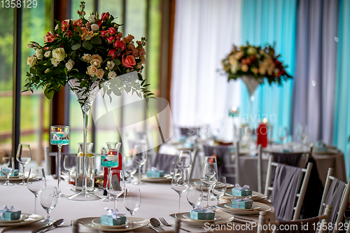 Image of Bouquet of flowers and glasses on the wedding table