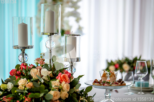 Image of Candles and flowers on festive table