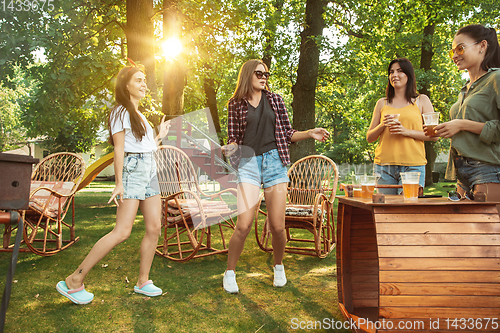 Image of Happy friends are having beer and barbecue party at sunny day