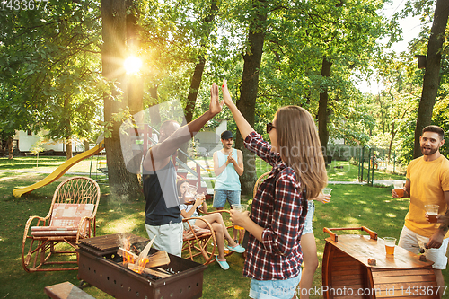 Image of Happy friends are having beer and barbecue party at sunny day