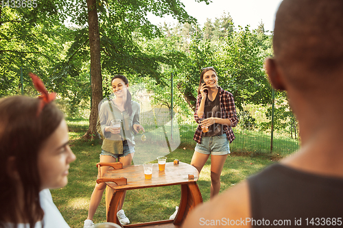 Image of Happy friends are having beer and barbecue party at sunny day