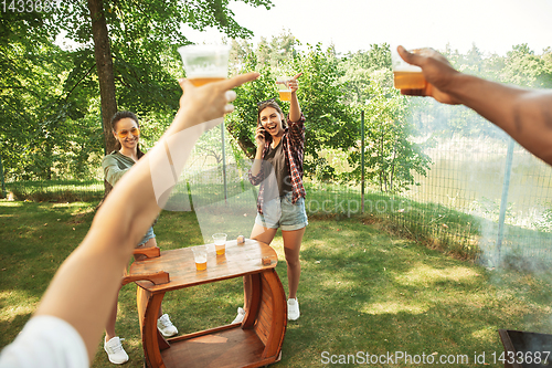 Image of Happy friends are having beer and barbecue party at sunny day