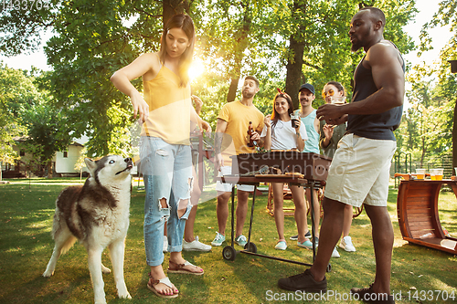 Image of Happy friends are having beer and barbecue party at sunny day