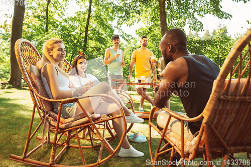 Image of Happy friends are having beer and barbecue party at sunny day