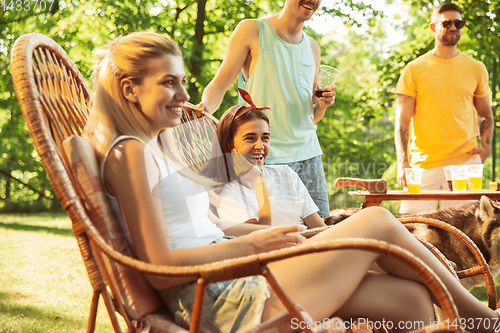 Image of Happy friends are having beer and barbecue party at sunny day