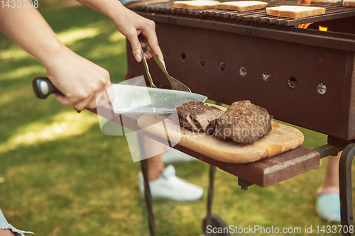 Image of Close up of meat grilling, barbecue, summer lifestyle