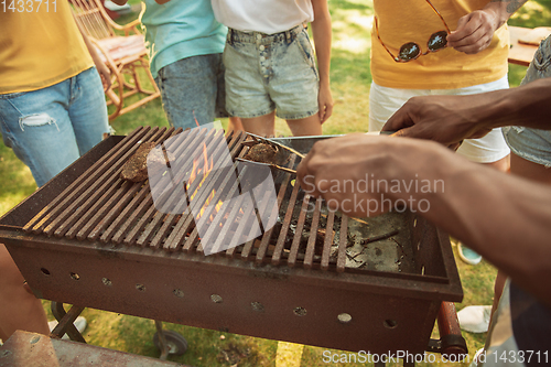 Image of Close up of meat grilling, barbecue, summer lifestyle