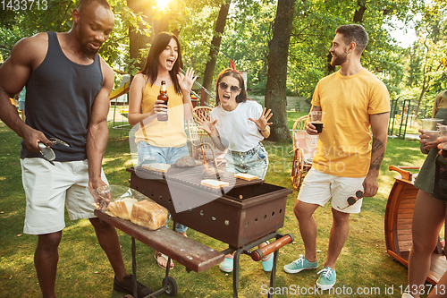 Image of Happy friends are having beer and barbecue party at sunny day