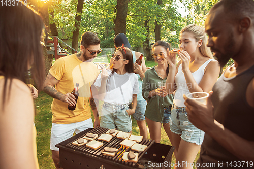 Image of Happy friends are having beer and barbecue party at sunny day