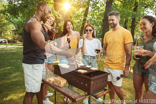 Image of Happy friends are having beer and barbecue party at sunny day