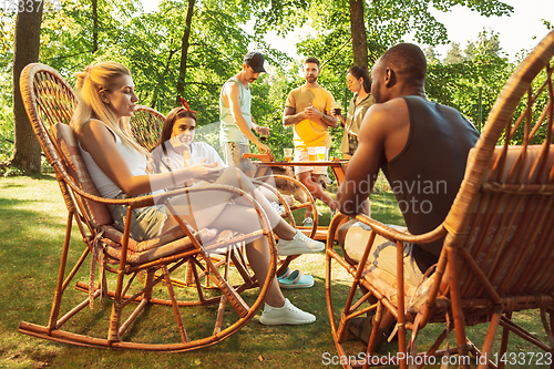 Image of Happy friends are having beer and barbecue party at sunny day