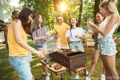 Image of Happy friends are having beer and barbecue party at sunny day