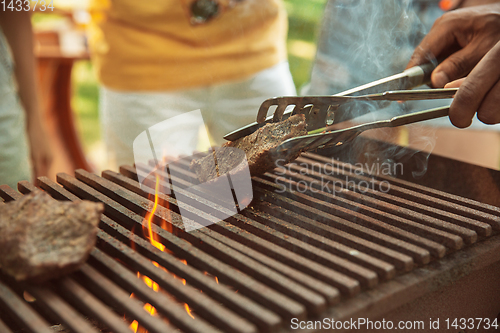 Image of Close up of meat grilling, barbecue, summer lifestyle