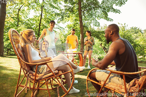 Image of Happy friends are having beer and barbecue party at sunny day