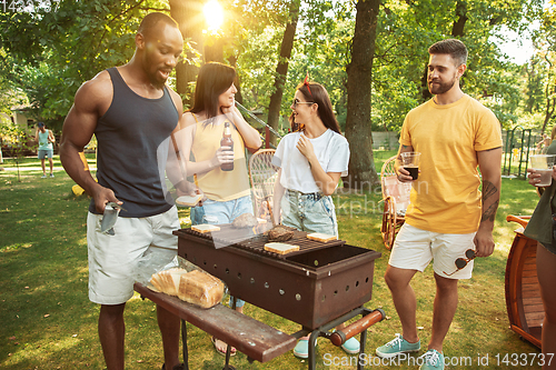 Image of Happy friends are having beer and barbecue party at sunny day