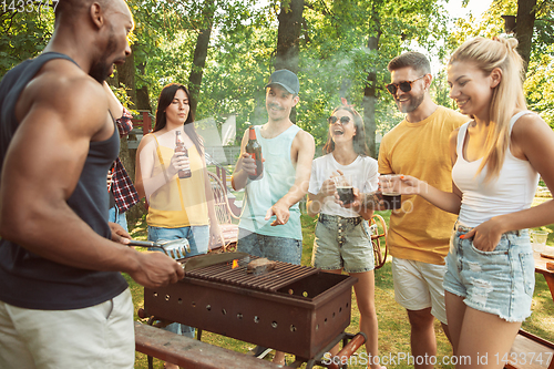 Image of Happy friends are having beer and barbecue party at sunny day