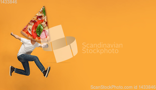 Image of Fast food concept. Young people running on orange background