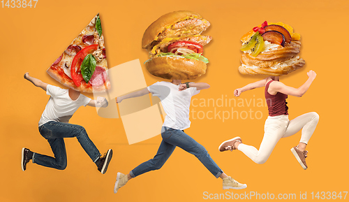 Image of Fast food concept. Young people running on orange background