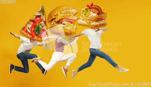 Image of Fast food concept. Young people running on orange background