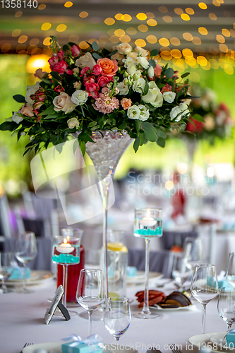 Image of Wedding table decorated with flowers and dishes