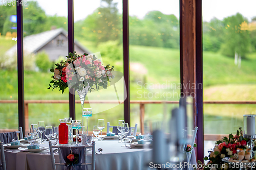 Image of Wedding table decorated with flowers and dishes