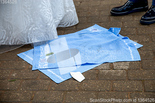 Image of Newlyweds, towels and broken plate pieces