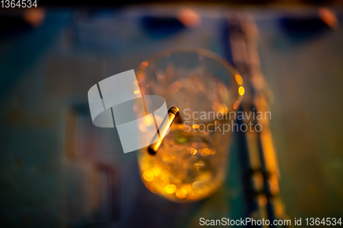 Image of Glass of cocktail in abstract lights
