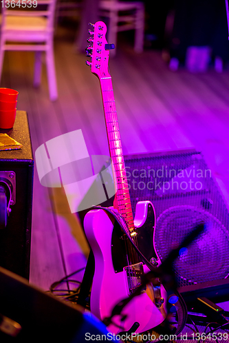 Image of Guitar and sound amplifier in abstract light